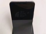 a close up of a cell phone that is on a stand