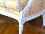 an image of a white chair with a yellow striped cushion