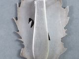 a silver spoon sitting on top of a piece of metal