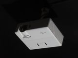 a video projector that is hanging from the ceiling in the dark