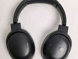 a pair of black headphones on a white surface