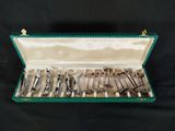 a green case with silverware in it on a black background