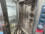a man standing in front of an open oven in a kitchen