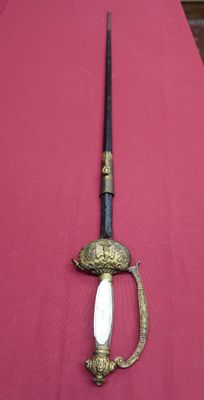 a sword on a table with a knife on it