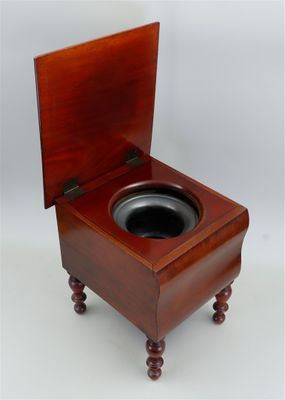 a small wooden toilet with a wooden seat on it
