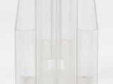 four clear vases sitting next to each other on a white surface