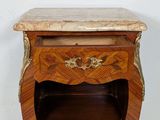a small wooden table with a marble top on it