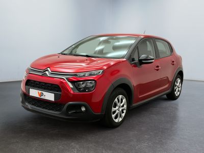 a red citrole is parked in a large room