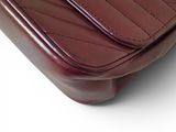 brown leather purse on a white surface with a white background