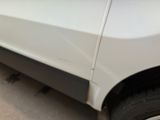 a close up of a white car parked in a parking lot
