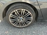 a close up of a car ' s tire on the road