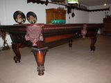 a pool table in the middle of a living room