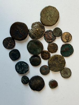 several different types of coins are displayed on a white surface