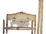 a bed with a wooden frame and two poles next to it