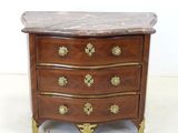 a marble top chest of drawers with brass handles