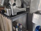 a machine that is sitting in a kitchen next to a trash can