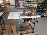 a sewing machine that is sitting on a pallet in a warehouse