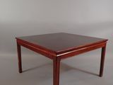 the table is made of wood and has a dark brown top