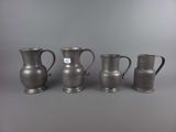 three silver vases with handles and handles on a gray background