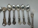 a lot of spoons and forks on the table