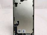 the back side of a cell phone with a metal frame and a small piece of metal