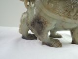 a statue of an elephant with a bird on its back