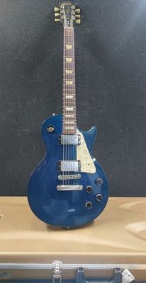 an electric guitar sitting on top of a blue case