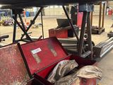 a red box with tools in it sitting on a shelf
