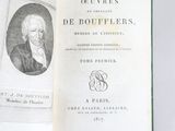 an open book with a picture of a man in a suit and tie