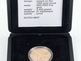 an image of a gold coin in a black case on a white background