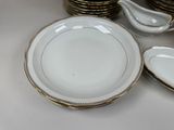 a lot of plates and bowls that are sitting on a table