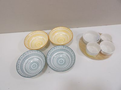 four bowls and two cups on the table