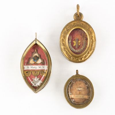 three gold and enamel lockes, one with a picture of a woman and one with a picture of a man