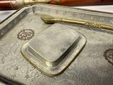 a silver tray with a spoon and a knife on top of it