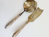 two spoons and a knife on a white table