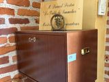a wall mounted cabinet with a clock on top of it
