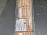 a long piece of bread wrapped in plastic sitting on a table