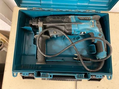 a blue box with a hammer and a cord in it