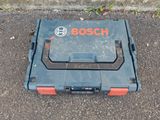 a close up of a tool box on the ground with a logo on it