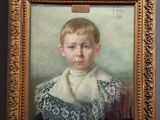 portrait of a young boy in a blue dress with a white collared shirt