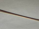 a long wooden stick that is laying on a table