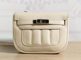 a small white purse sitting on a wooden table