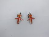 a pair of red and white enamel doll earrings