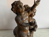a small statue of a child sitting on a tree stump