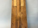 an image of a wooden clock on a stand against a white background