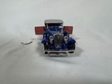a blue toy car with a red roof on a white surface