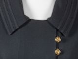 a close up of a black jacket with gold buttons