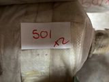 a label on the back of a teddy bear that is sitting on a chair