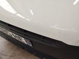 a close up of a white car with a license plate on it