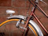 a close up of a bicycle with a brick wall in the background